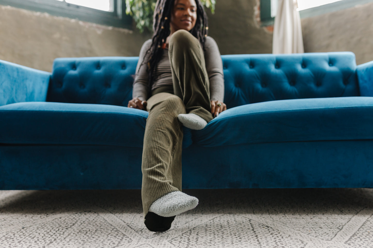 Whale Watch | Bay Gray Cozy Socks | Fuzzy Socks | Cozy Socks for a Cause- on feet, blue couch